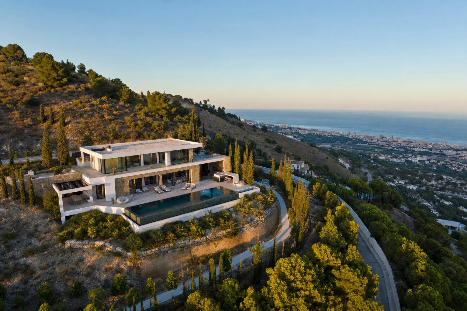 Aerial view of the villa set into the Benalmádena hillside above the coast